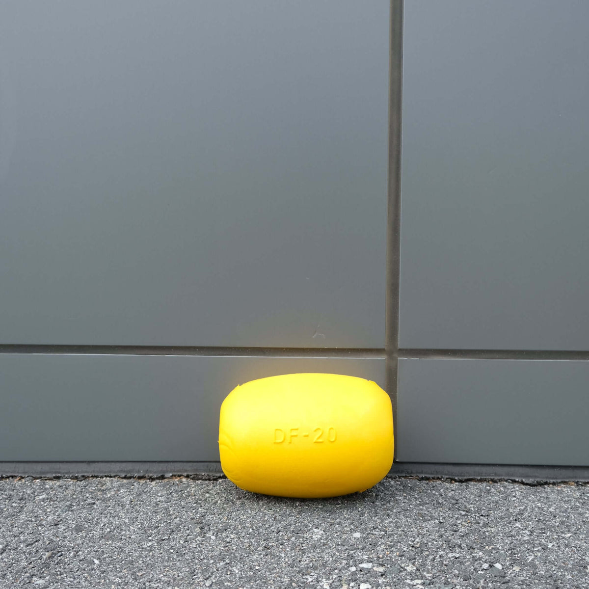 FLOAT EVA DF-20, 176MM X 135MM yellow buoy resting against a grey wall, suitable for stinger nets and shark barriers.