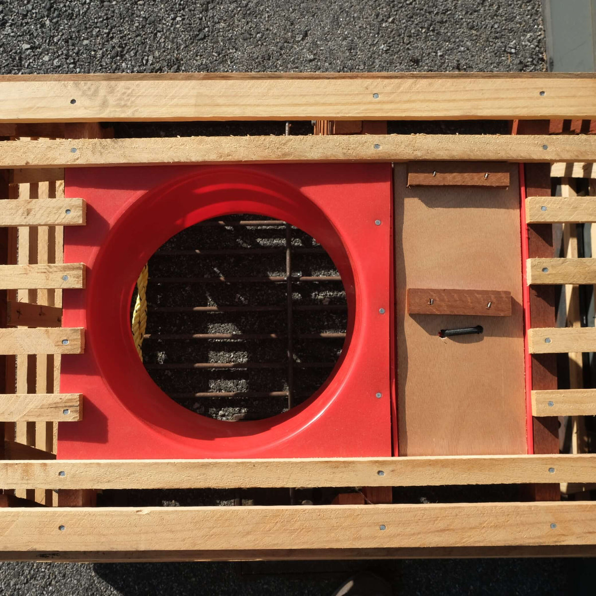 3/4 POT SB JR/PI 1 BASKET showing red circular opening and wooden slats for support.