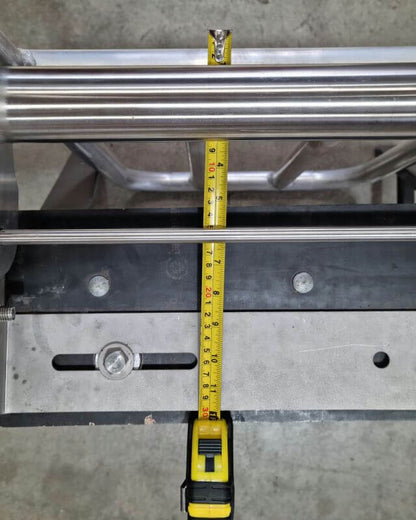 Measuring the width of the Tipper Crackpots XL with a tape measure on its stainless steel frame.