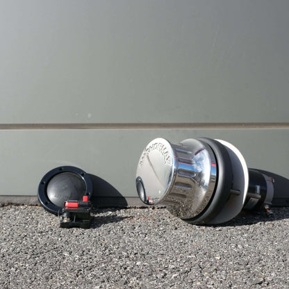 WINCH ANCHORMAX 12V F/S components arranged on a gravel surface with a grey backdrop.