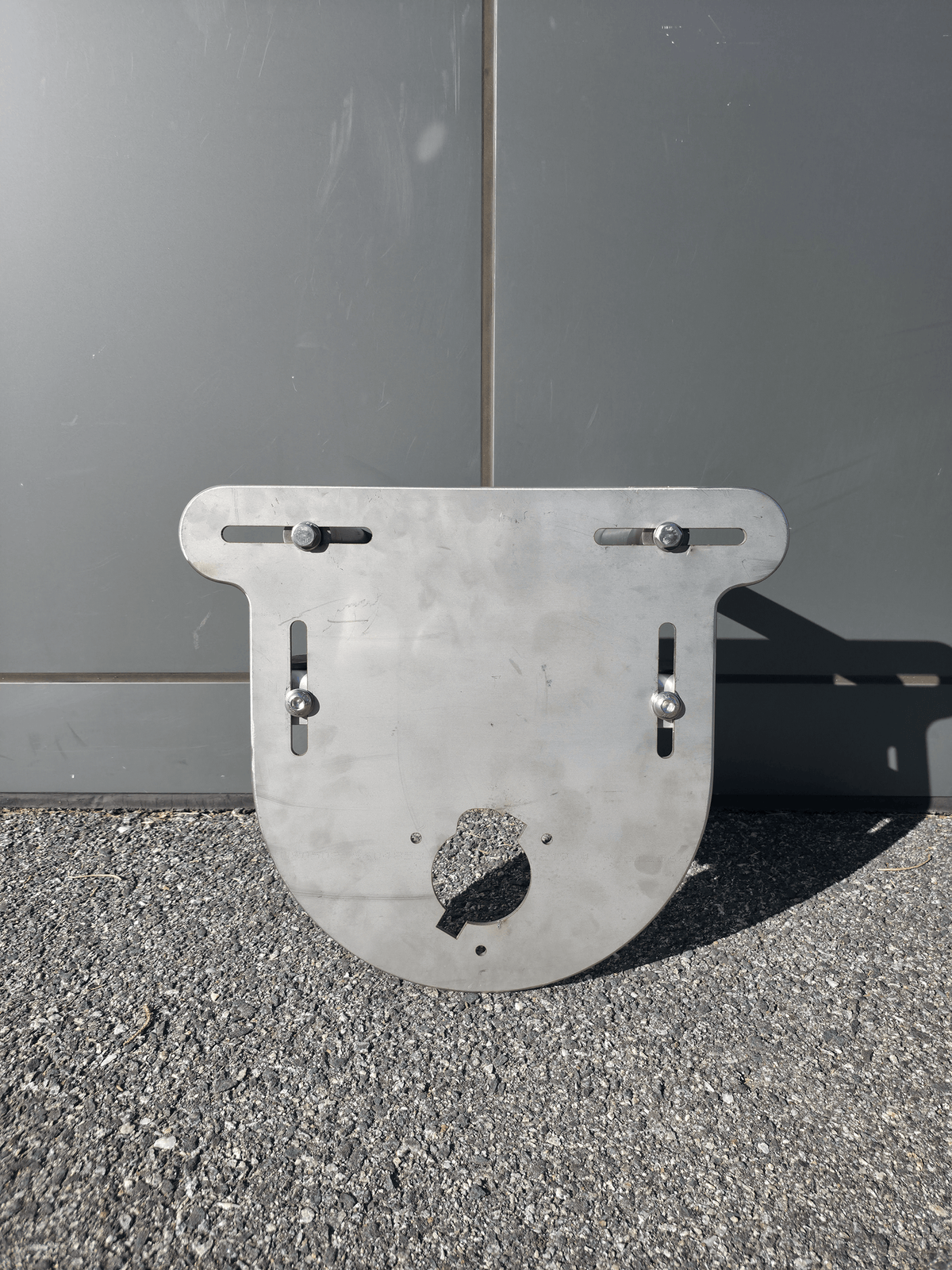 Adjustable Winch Mount for marine use, featuring a durable metal design and clamp attachment for easy removal.