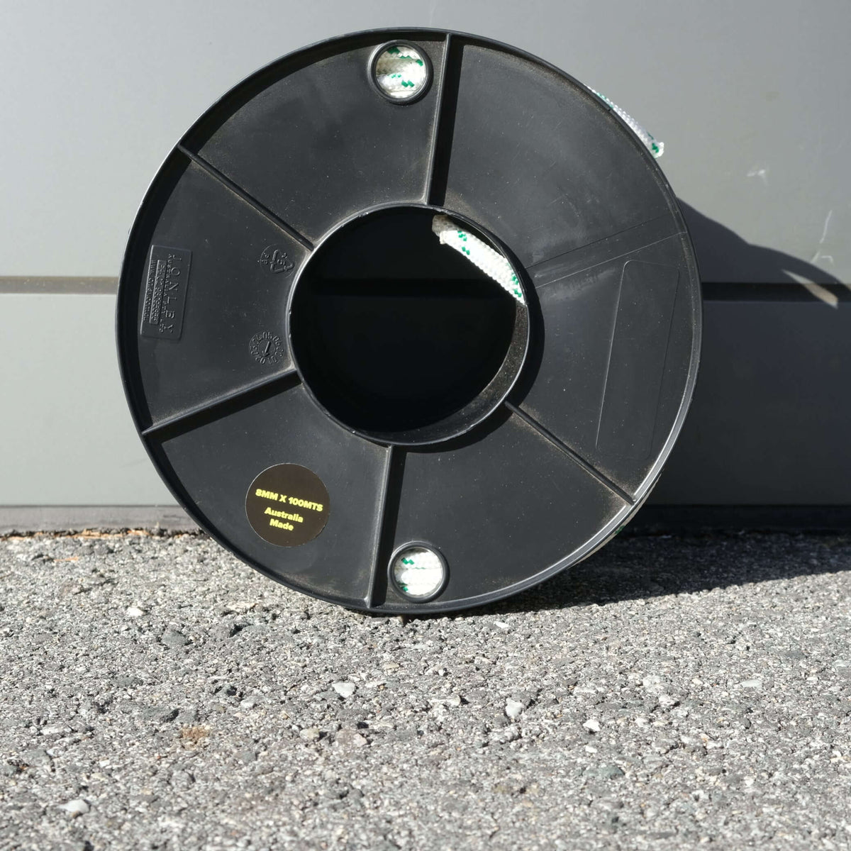 ROPE DB BRAID 8MM X 100M spool on asphalt surface, showcasing high-quality Australian-made material.