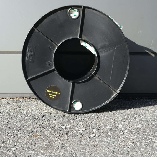 ROPE DB BRAID 8MM X 100M spool on asphalt surface, showcasing high-quality Australian-made material.