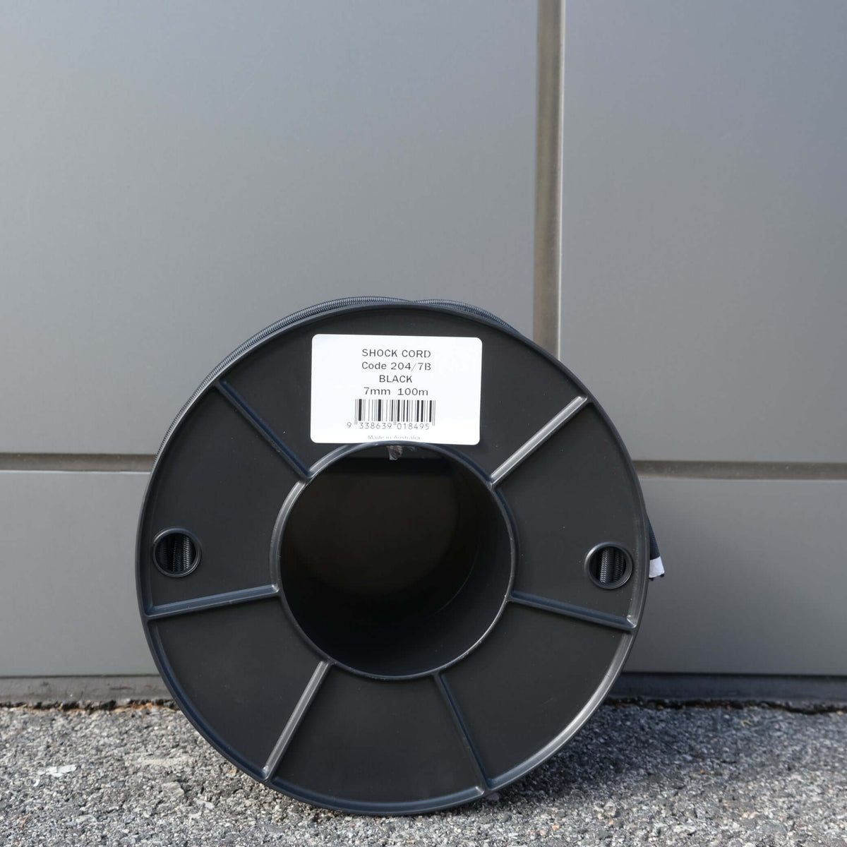 SHOCK CORD 7MM X 100M BLK on a spool, ideal for securing gates and lids with durability and reliability.