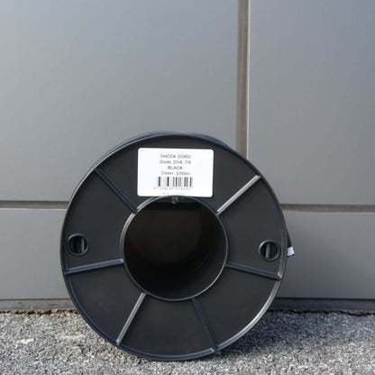 SHOCK CORD 7MM X 100M BLK on a spool, ideal for securing gates and lids with durability and reliability.
