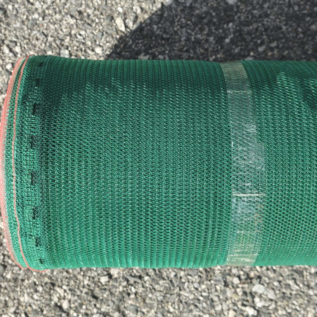 SHADECLOTH 35% 1.83M X 50M GRN roll showcasing green shadecloth texture and reinforced edges for plant protection.